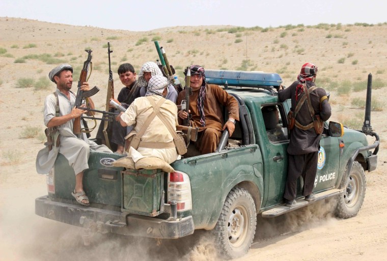 Image: Afghan Local Police sit at the back of a truck