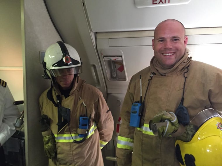 Image: Firefighters aboard United Airlines Flight UA935 on Aug. 7, 2015