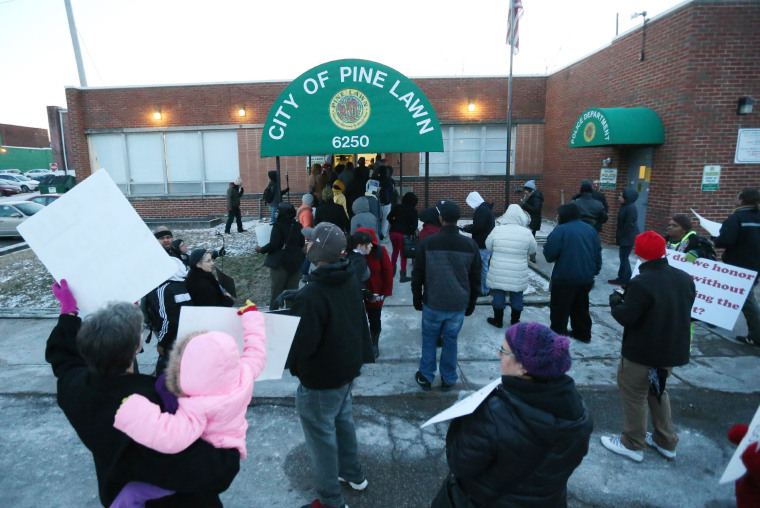 Protesters block the entrance to the Pine Lawn City Hall on Thursday, Feb. 5, 2015, in Pine Lawn, Mo.  The protesters were trying to prevent people from entering or exiting the city's municipal court, thereby disrupting the court's ability to collect fines.