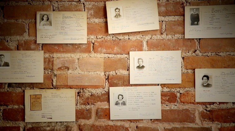 Image: On the wall, cards with pictures of La Nacional’s members.
