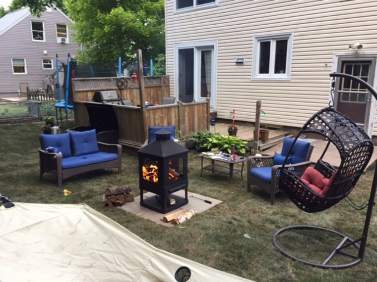 The backyard makeover included new furniture, a swing, and a fire pit.