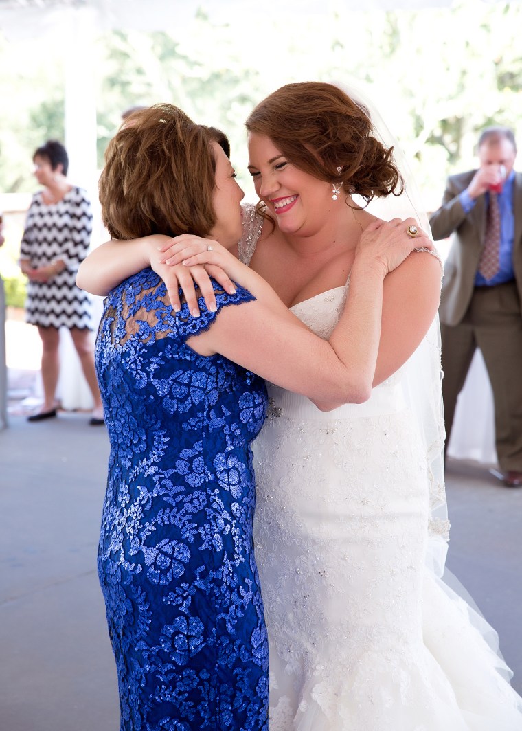 Bride and mom embrace