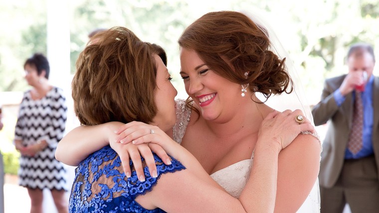 Bride and mom embrace