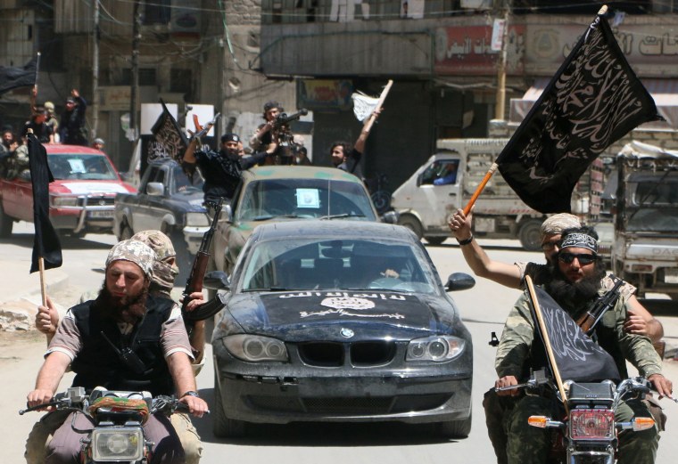 Image: Fighters from Al-Qaeda's Syrian affiliate Nusra Front drive in the northern Syrian city of Aleppo