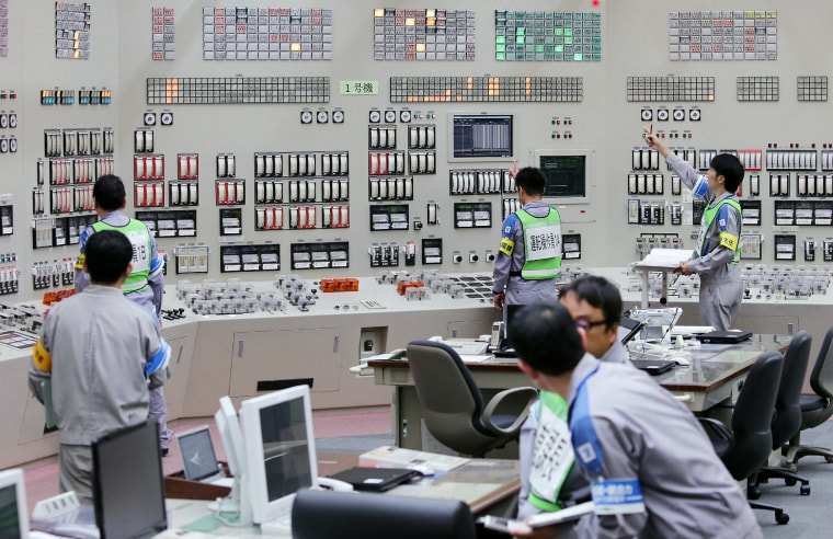 Image: Operators restart the nuclear reactor at the central control room of the Kyushu Electric Power Sendai nuclear power plant