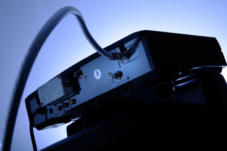 A cable box is seen on top of a television on  May 30, 2007.