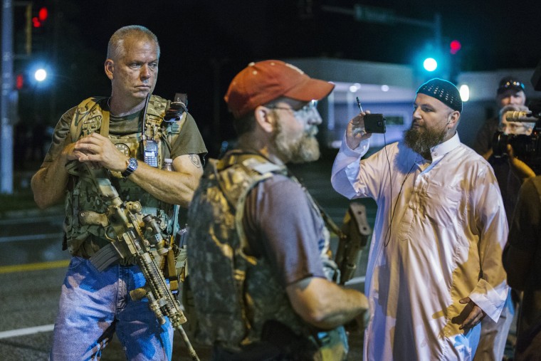 Image: Members of the Oath Keepers walk with their personal weapons on the street during protests in Ferguson, Missouri