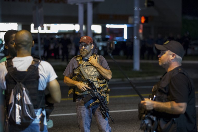 Image: Members of the Oath Keepers walk with their personal weapons on the street during protests in Ferguson, Missouri