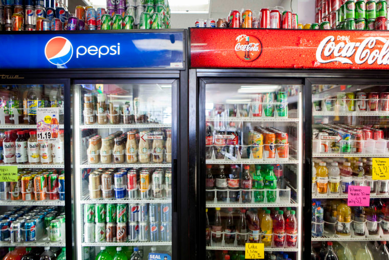Image: Cans of soda are displayed in a case at Kwik Stops Liquor in San Diego