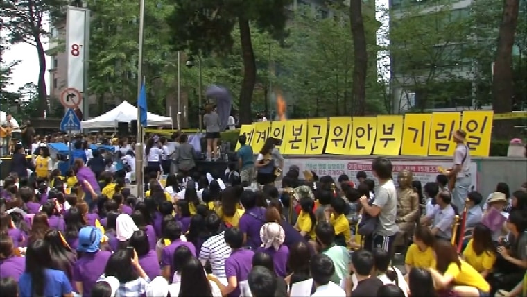 Image: The protester set himself alight behind a wall of placards