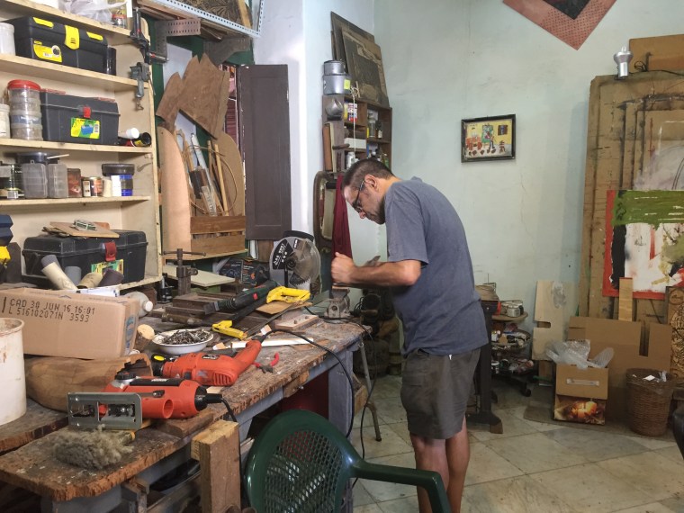 Artist Angel Ramirez works in his studio.