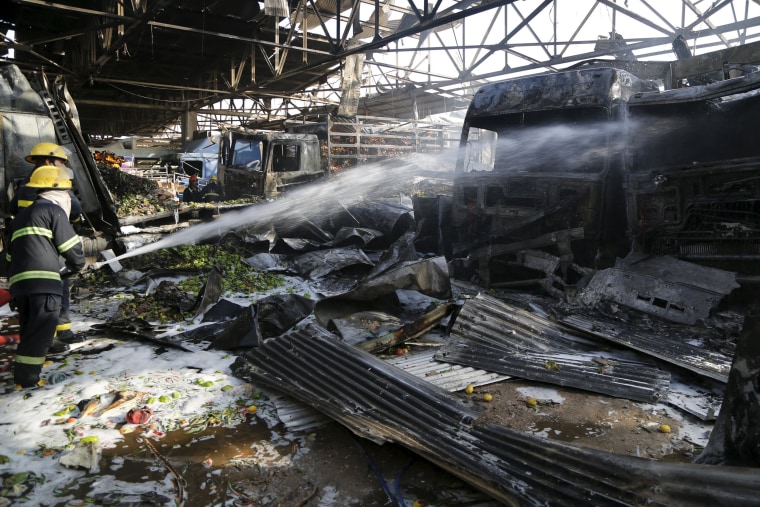 Image: Firefighters at scene of blast in Baghdad market