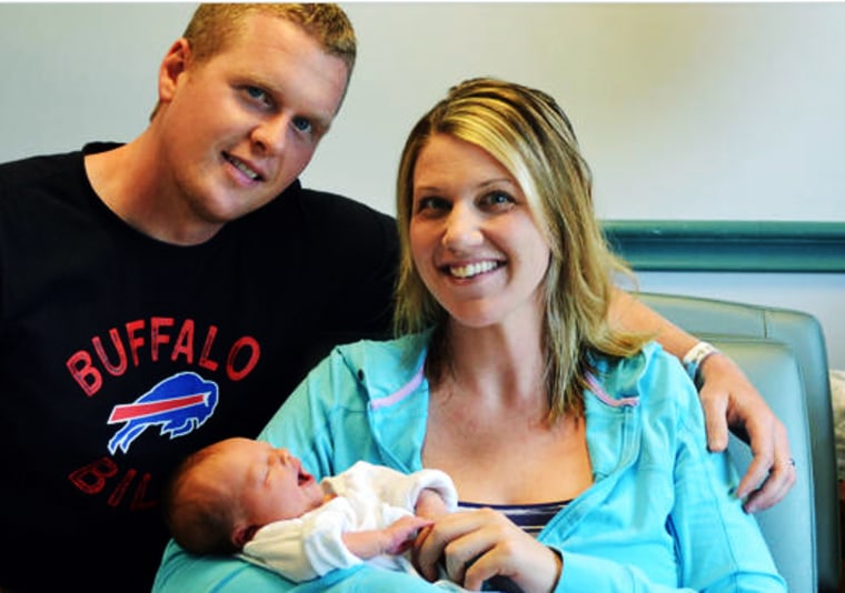 Image: Stephanie and Jason Brueggeman pose with their newborn daughter at the hospital in Buffalo, N.Y.