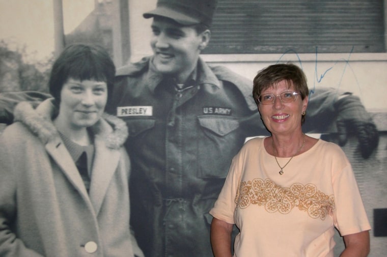 Image:  Angelika Springauf in 2015 posing in front of a poster of her picture with Elvis