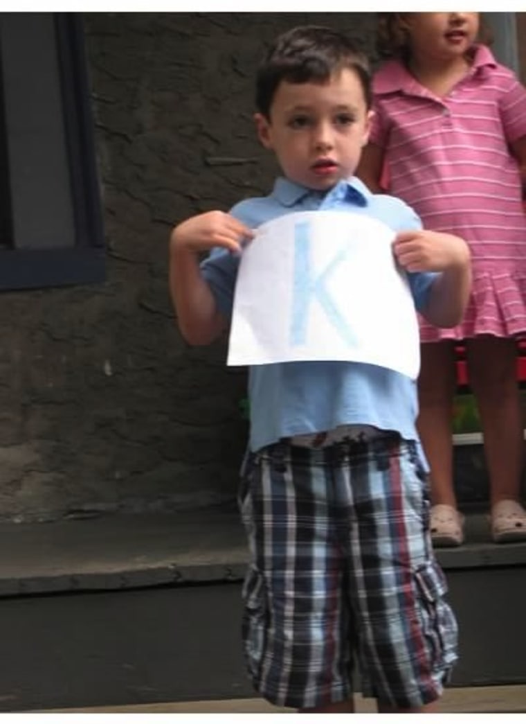 Boy holding a K sign