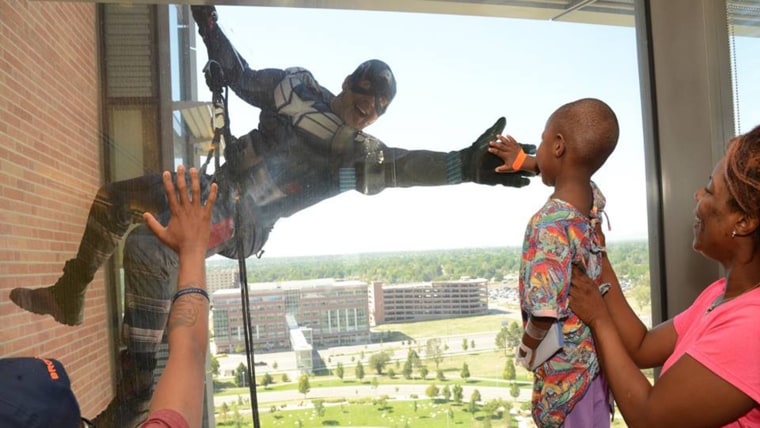 Police dress up as superheroes to surprise hospital kids