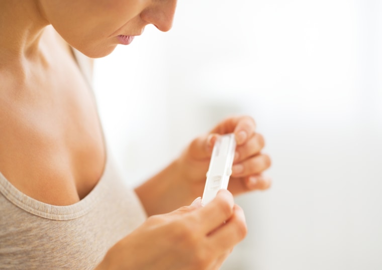 Woman checking a pregnancy test