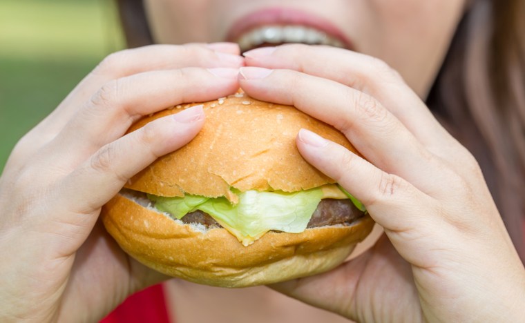 Woman eating a hamburger