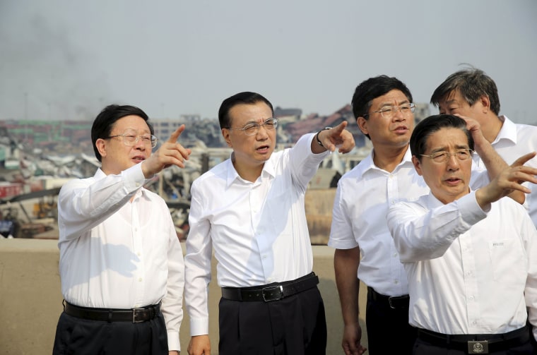Image: China's Premier Li Keqiang gestures as he visits the site of the explosions at Binhai new district, Tianjin