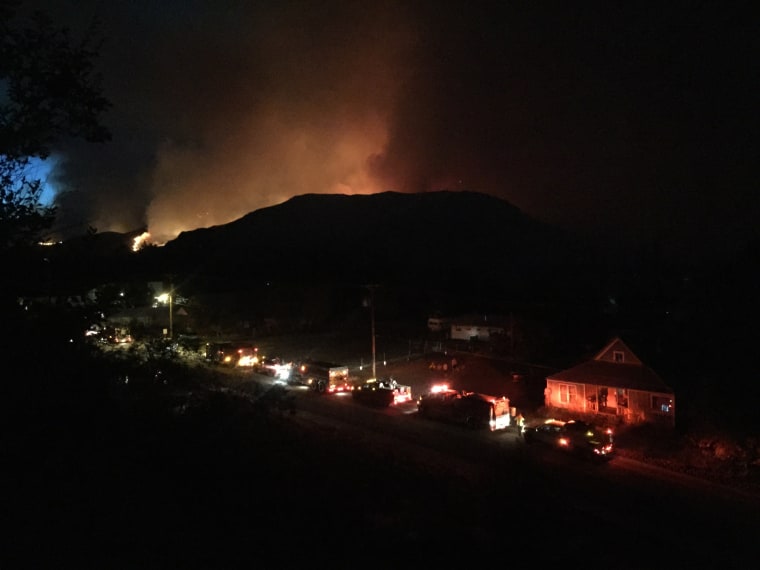 Image: Fires light up the night sky over Twisp, Washington, where three firefighters died late Wednesday.