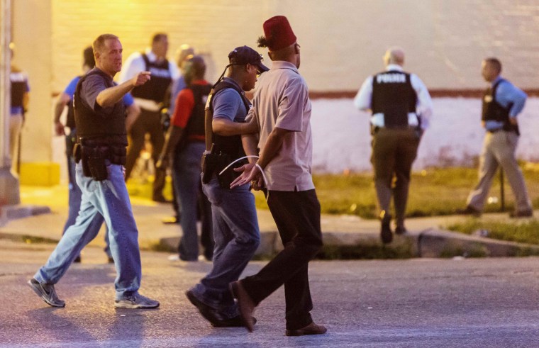 Image: Police arrest a man as protesters gathered after a shooting incident in St. Louis
