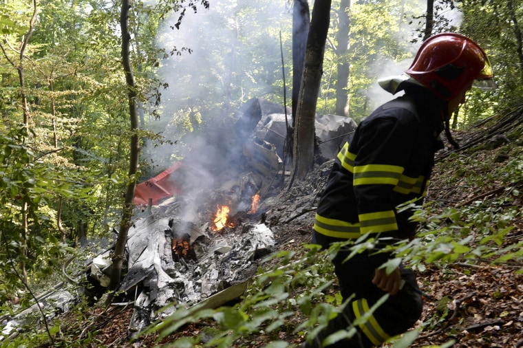 Image: Firefighter inspects the crash site near Cerveny Kamen, Slovakia
