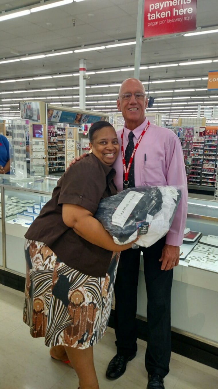 Kmart store manager Mark Weatherby poses with one of his customers.