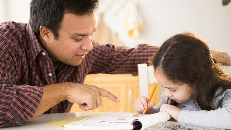 Father helping daughter with homework