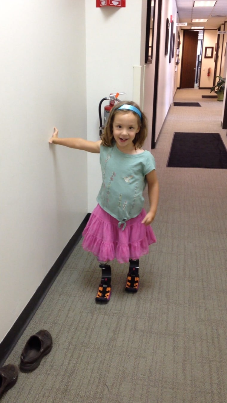 Ellie, age 4, gets her new prosthetic running legs.