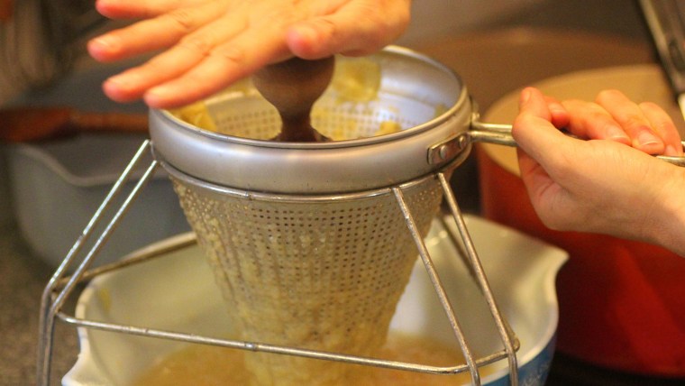 Making applesauce with a food mill