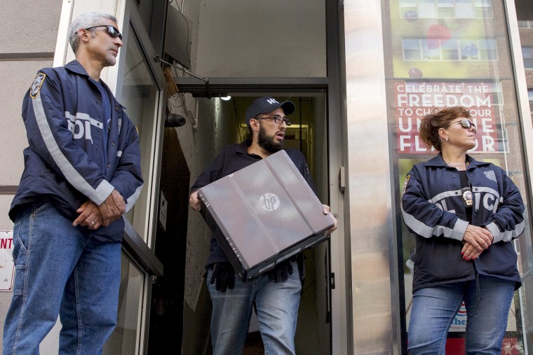 Image: Officers seize evidence from the Manhattan offices of Rentboy.com