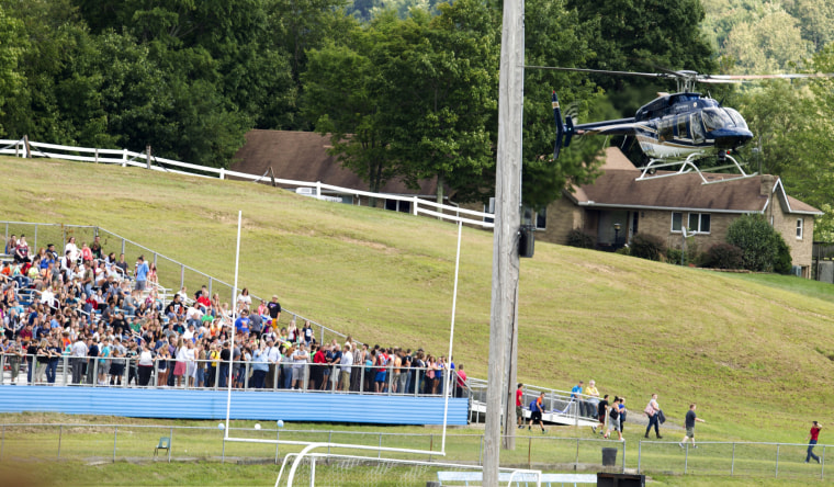 Image: A West Virginia State Police helicopter lands on the football field at Philip Barbour High School