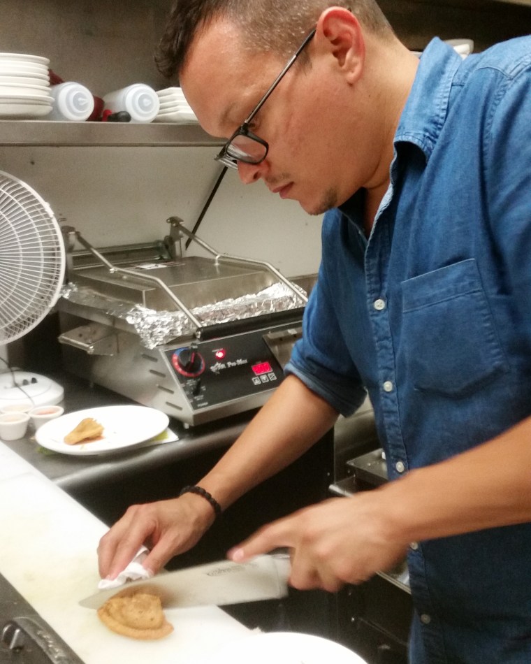 Image: Alex Carabaño prepares a Philly style empanada