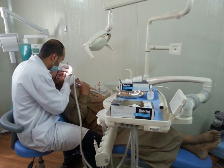 Image: A patient is treated at the Amiriyat Al-Fallujah Refugee camp