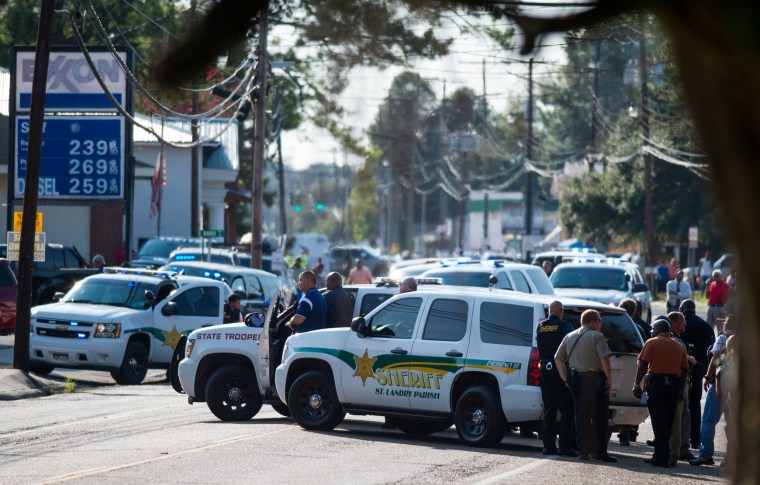 Image: Police gather at the scene of a shooting in Sunset, La.
