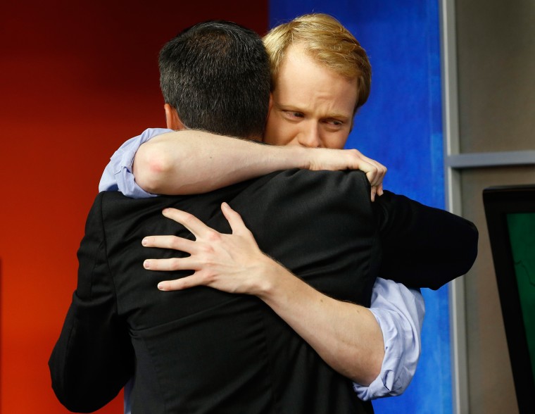 Image: WDBJ-TV7 anchor Chris Hurst, right, hugs meteorologist Leo Hirsbrunner