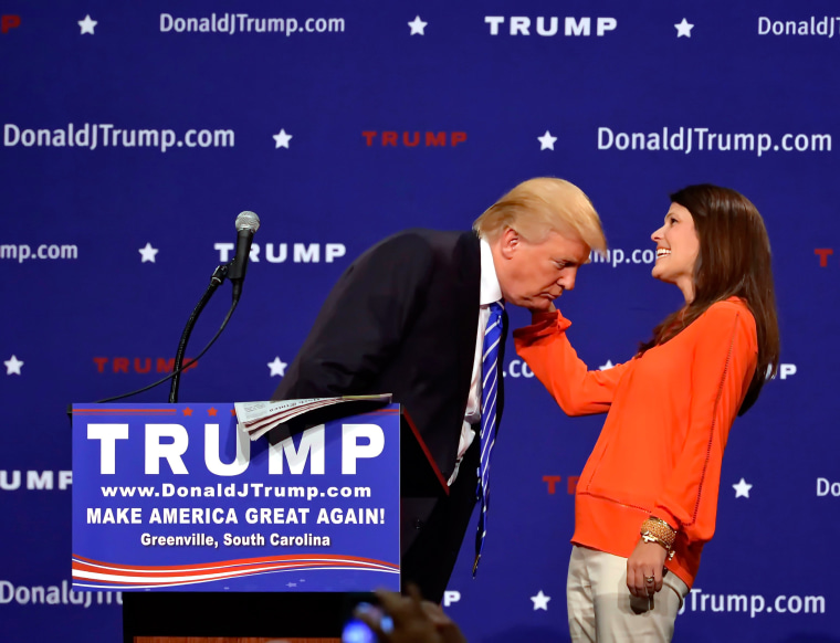 Image: Donald Trump supporter Mary Margaret Bannister checks to see if his hair is real