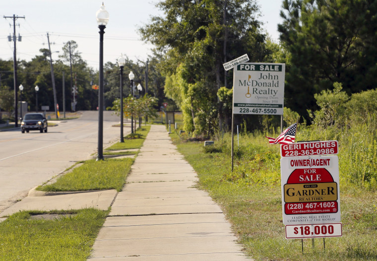 Image: For sale signs are seen on Coleman Avenue in Waveland, Mississippi
