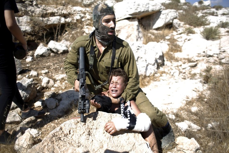 Image: An Israeli soldier detains Mohammed Tamimi