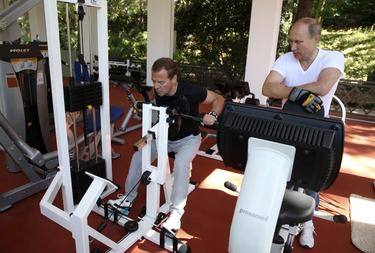 Image: Russian President Putin and Prime Minister Medvedev exercise in a gym at the Bocharov Ruchei state residence in Sochi