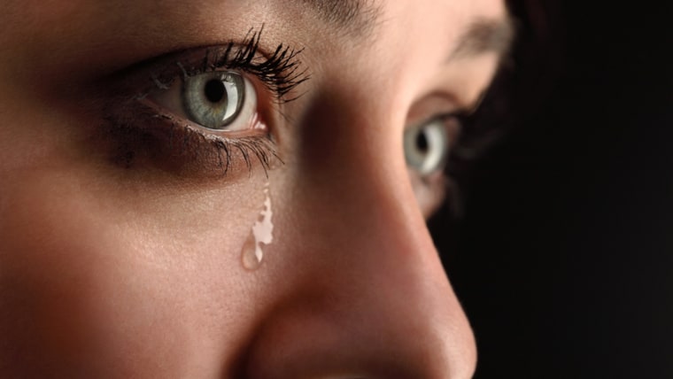 Woman cries, up close.