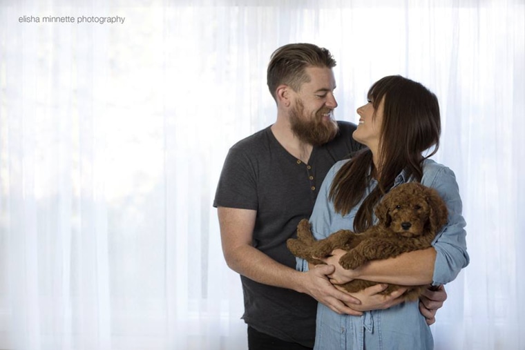 Couple poses with dog for "baby" photos