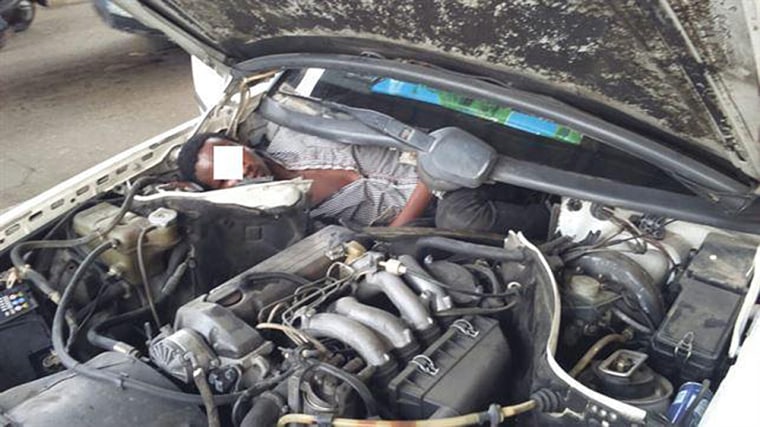 Spanish police found a migrant hiding in a compartment next to a car engine as the vehicle crossed into Europe.