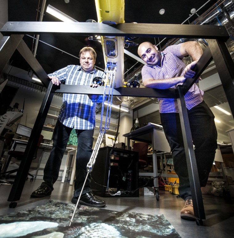 Matt Dunbabin (left) and Feras Dayoub with the COTSbot robot which is designed to search for and kill Crown of Thorns Starfish.