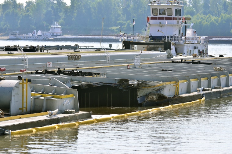 Image: Damage on a barge is seen as it is moored along the Kentucky shore of the Mississippi River