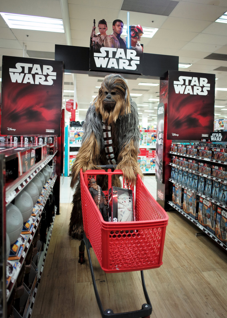 Image: A fan dressed as Chewbacca shops for merchandise from the upcoming film 'Star Wars: The Force Awakens