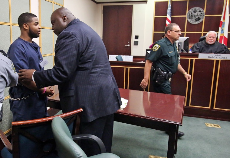 Image: Former FAMU percussionist Caleb Jackson, left, confers with his attorney