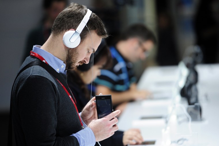 Image: A man listens to music.