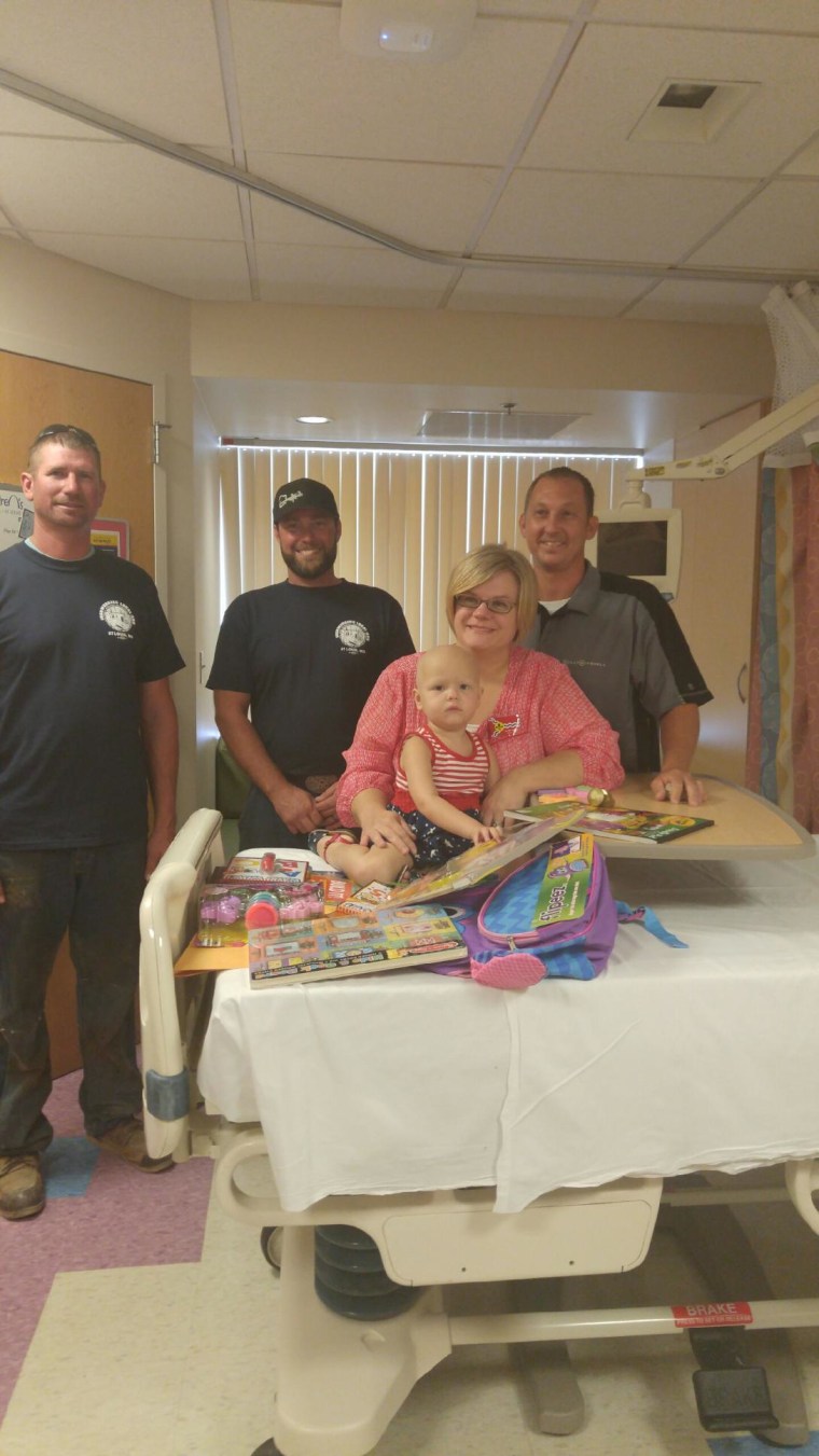 The Keith family meets construction workers who wrote 'get well' messages at St. Louis Children's Hospital.