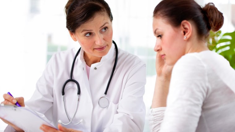 woman speaking with female doctor